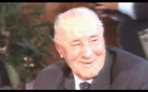 an older gentleman who is smiling and talking