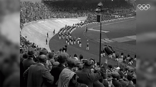large crowd in a stadium with spectators at the end