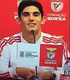 a male soccer player giving a speech to the media