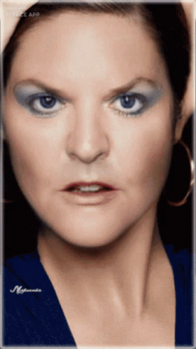 a portrait of a woman with blue makeup and hair