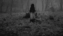 a woman sitting on the ground with a ghost like face