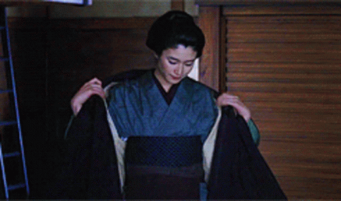 a woman in kimono looking at the screen
