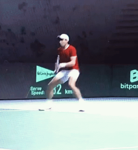 a man swinging a tennis racquet on top of a tennis court