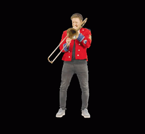 a male in a blue jacket holding a trombone