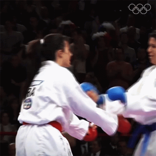 two men in karate outfits holding each other