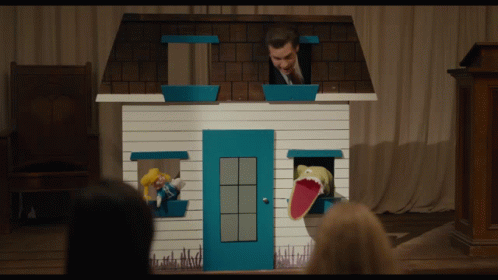 a couple of puppets in the shape of house