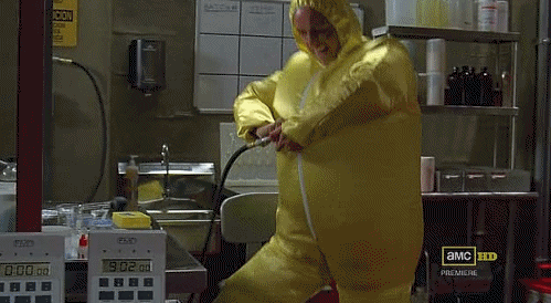 person in a blue costume walks inside of a large lab