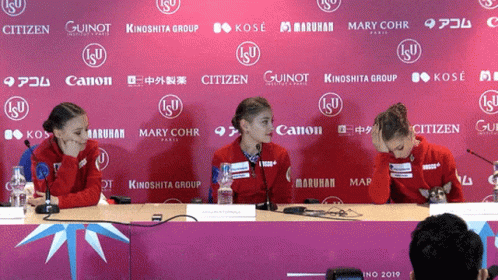 the two girls are talking at the press conference