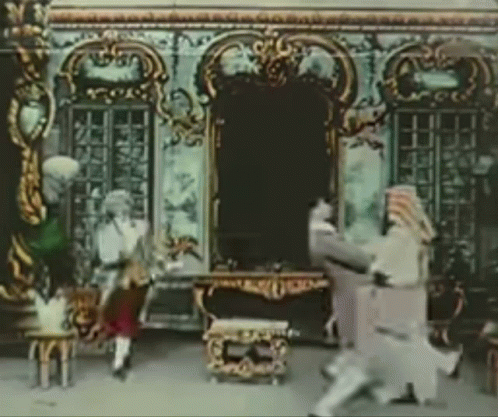a screen with a picture of children on a stage and in costume