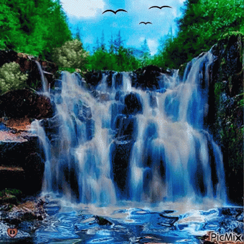 a picture of a waterfall with birds flying above
