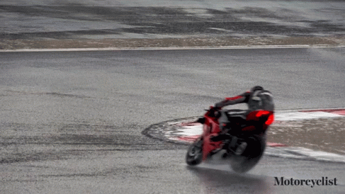 a motorcyclist is taking a turn on the track