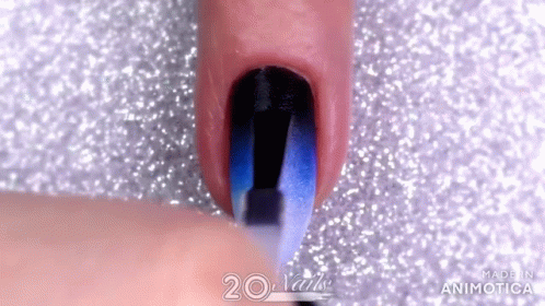 an image of a nail being decorated with glitter