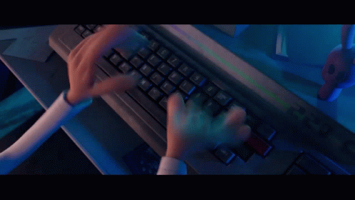 a woman typing on a keyboard in front of a computer monitor