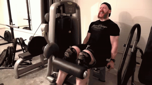 man using the weights on a machine in the gym