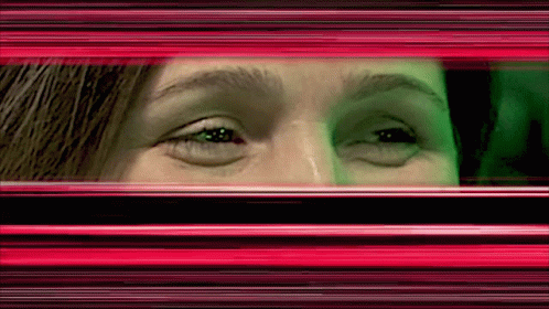 a woman looking over her eyes in front of the window