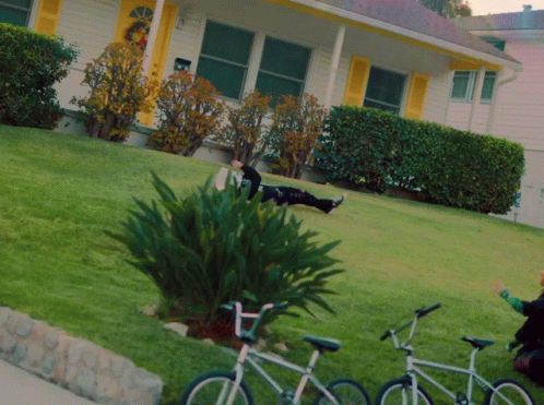 there are two bicycles parked on the side of the house