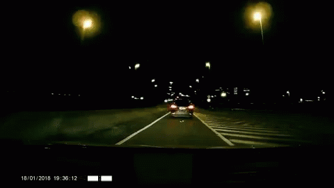a car traveling on a city street at night