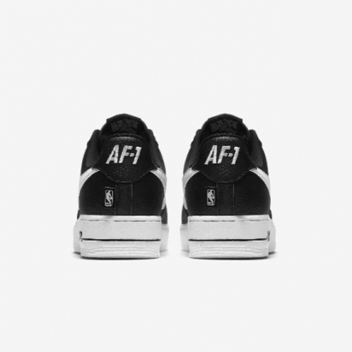 black and white shoes with white letters that say af1
