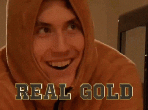 a person wearing a hoodie with a big smile and the words real gold
