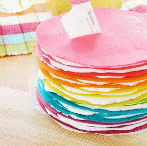 the table has plates of colorful, multicolored cloth