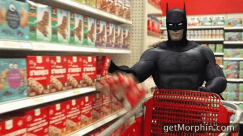 a person with an inflatable batman mask is hing a shopping cart
