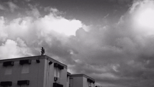 black and white po of buildings with dark clouds