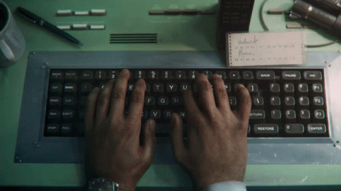 man typing on keyboard with both hands