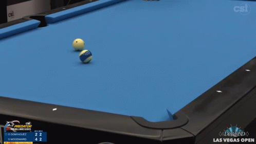 two balls are positioned on an orange pool table