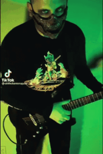a person standing up playing an electric guitar