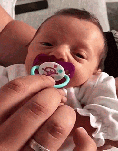 there is a baby with a pacifier in it's mouth
