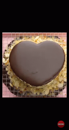a blue cake with a black heart on top