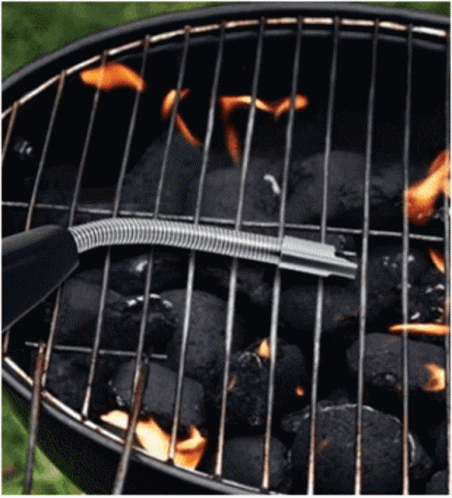 a fork that is cooking some food on a grill