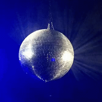 a disco ball is hanging from the ceiling in a dark room
