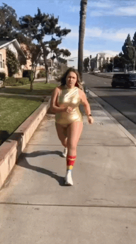 a woman running down a sidewalk in her underwear