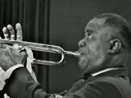 a man holding a trumpet in his right hand