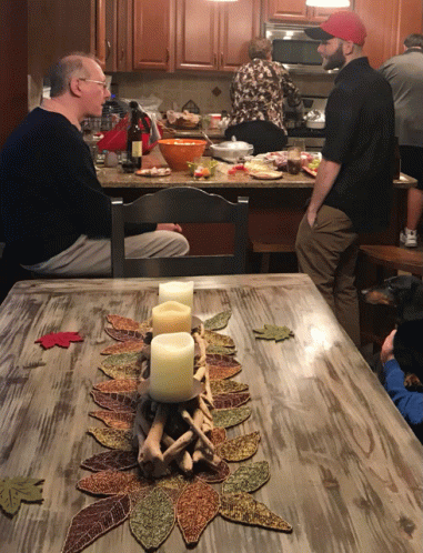 a bunch of people gathered around a dinner table