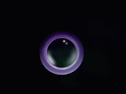 a blurry circular object is in the dark
