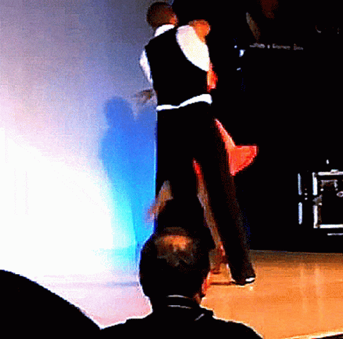 two dancers wearing black and white on a stage