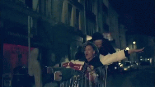 a man is in a cart carrying an older woman