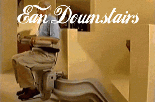 a man who is sitting in a chair with the word san downstatirs above it