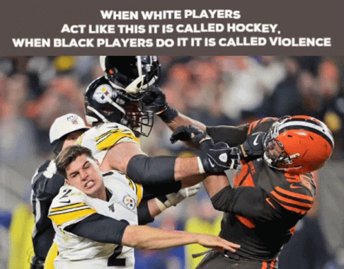 a football player attempts to block the play for a loose ball while another tries to keep his eye on him