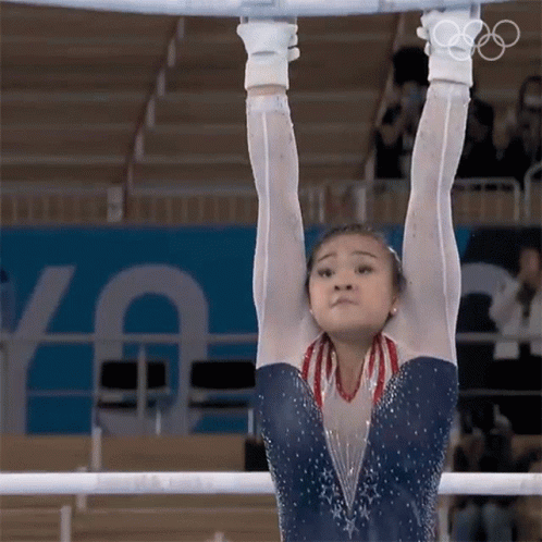 the young woman is doing gymnastics on the rings