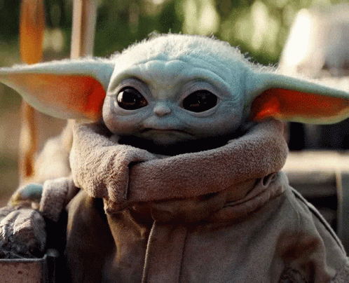 a baby yoda is sitting on a table