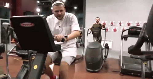 a man sitting in front of an exercise bike