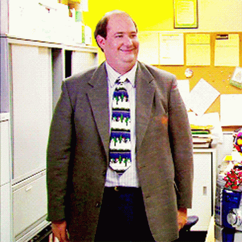 an office worker standing in his cubicle wearing his tie