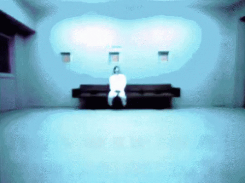 a blurry po of a room with a couch and a person