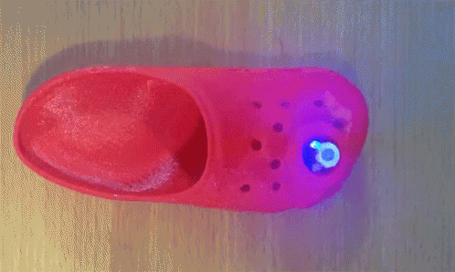 a purple and red light with red dots in a wall