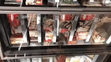 many packaged items in a supermarket case are being stored