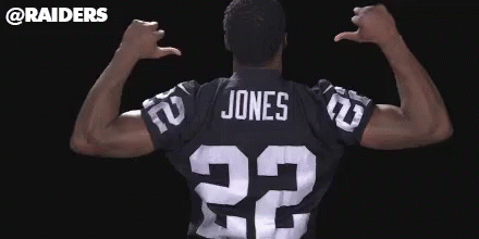 a man is standing wearing a jersey that reads 32 and jones