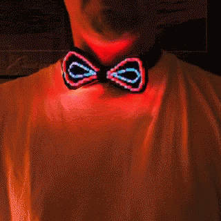 a man in blue shirt wearing a black light up bow tie